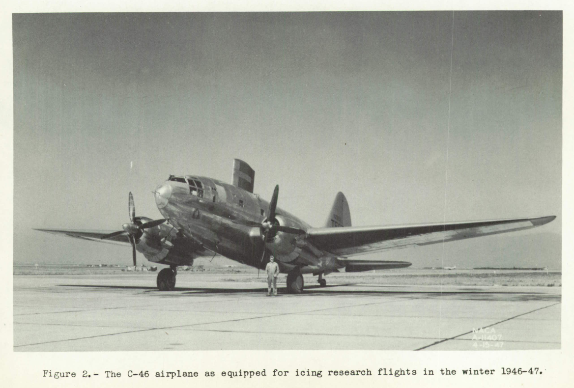 Figure 2. The C-46 airplane as equipped for icing research flights the winter of 1946-47.
A C-46, a large two engine, propeller driven low-wing airplane. It is modified for icing flight test, with a large (8 ft. by 5 ft.) test airfoil is mounted on top of the body. 'TEST' is emblazened on the tail.
